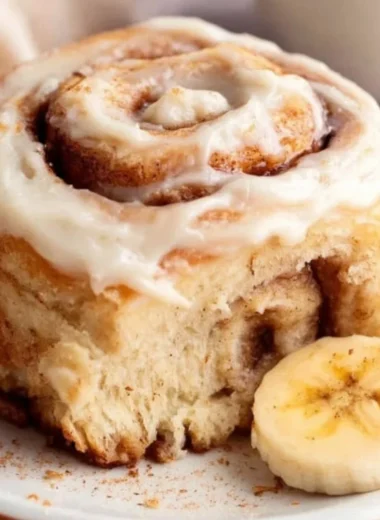 Delicious banana bread cinnamon rolls topped with creamy frosting