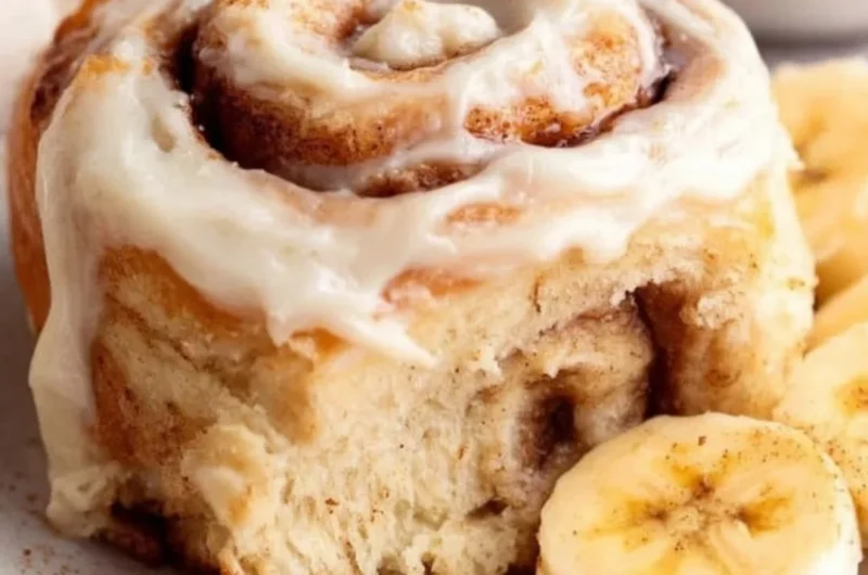 Delicious banana bread cinnamon rolls topped with creamy frosting