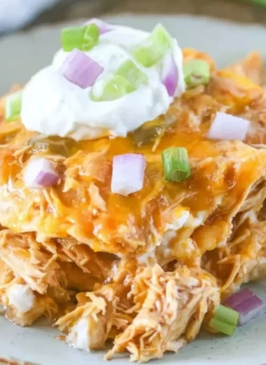 Delicious Chicken Enchilada Casserole topped with cheese and jalapeños