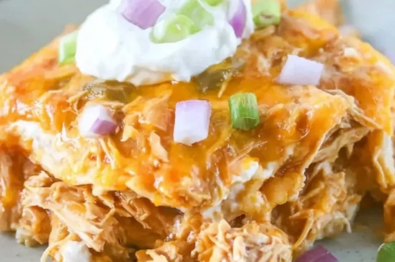Delicious Chicken Enchilada Casserole topped with cheese and jalapeños