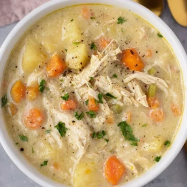 Delicious Chicken Pot Pie Soup served in a bowl, garnished with parsley.