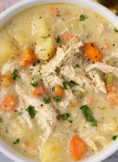 Delicious Chicken Pot Pie Soup served in a bowl, garnished with parsley.