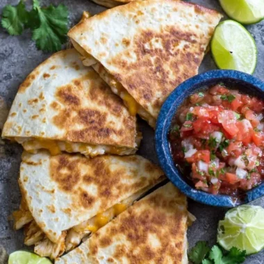 Delicious homemade Chicken Quesadillas served with salsa and guacamole.