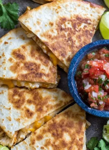 Delicious homemade Chicken Quesadillas served with salsa and guacamole.