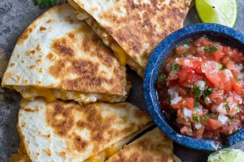 Delicious homemade Chicken Quesadillas served with salsa and guacamole.