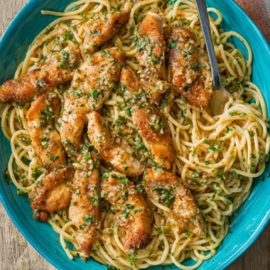 Delicious Chicken Scampi Pasta topped with herbs and served in a bowl.