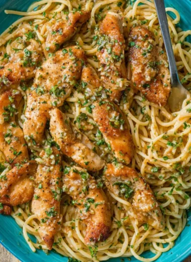 Delicious Chicken Scampi Pasta topped with herbs and served in a bowl.