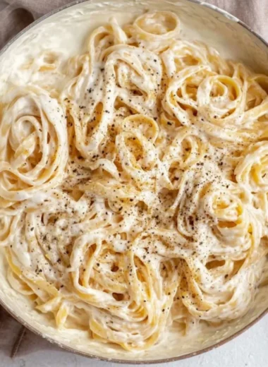Delicious Cottage Cheese Alfredo sauce over pasta topped with herbs.