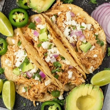 Delicious Crockpot chicken tacos served with toppings