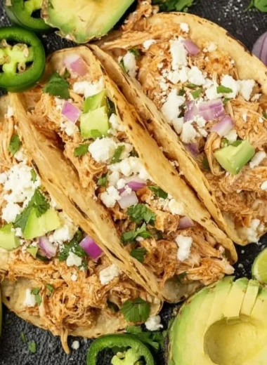Delicious Crockpot chicken tacos served with toppings