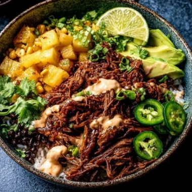 Crockpot chipotle pineapple pot roast served in a bowl with fresh herbs.