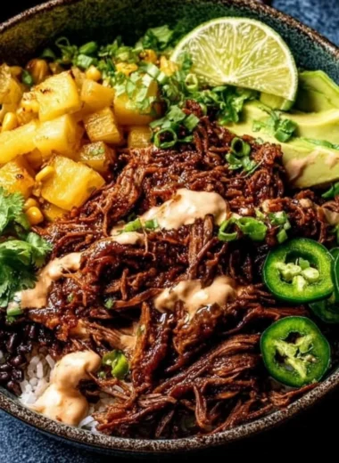 Crockpot chipotle pineapple pot roast served in a bowl with fresh herbs.