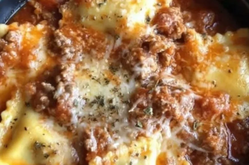 Crockpot Ravioli Lasagna served with fresh herbs and melted cheese