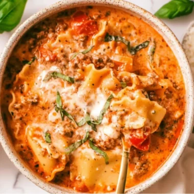 Bowl of easy creamy lasagna soup topped with cheese and herbs