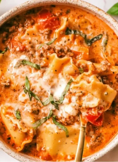 Bowl of easy creamy lasagna soup topped with cheese and herbs