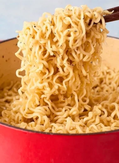 Delicious bowl of Garlic Butter Ramen Noodles garnished with herbs