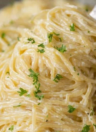 Delicious bowl of Garlic Parmesan Pasta topped with parsley and grated parmesan cheese.