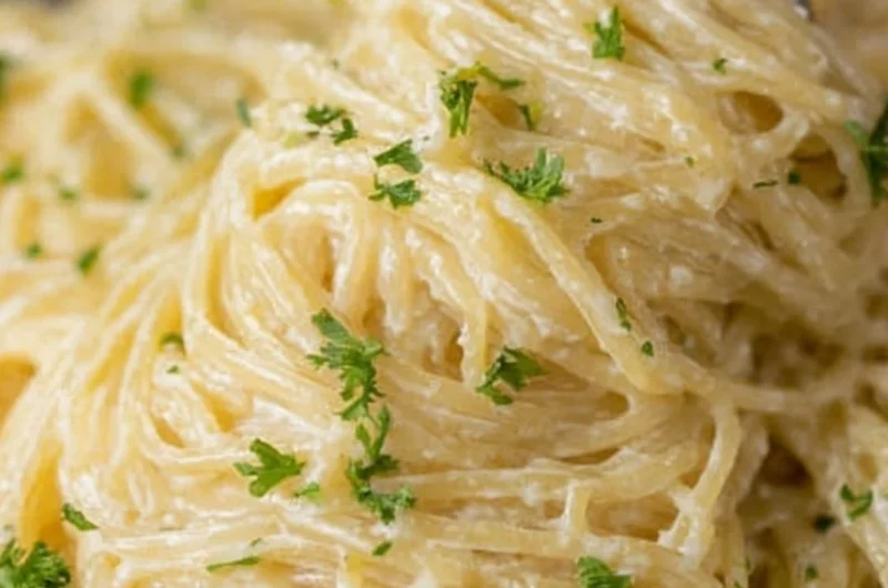 Delicious bowl of Garlic Parmesan Pasta topped with parsley and grated parmesan cheese.