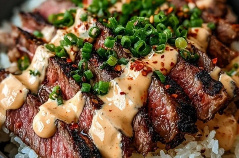 Korean BBQ steak rice bowl served with vegetables and sauce.