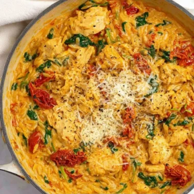 Marry Me Chicken One Pot Pasta served in a bowl with herbs and cheese on top.