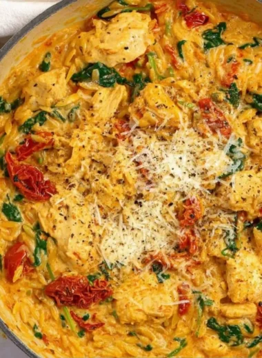 Marry Me Chicken One Pot Pasta served in a bowl with herbs and cheese on top.