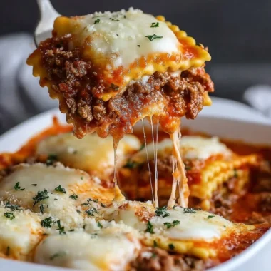 Delicious Million Dollar Ravioli Casserole topped with melted cheese and herbs
