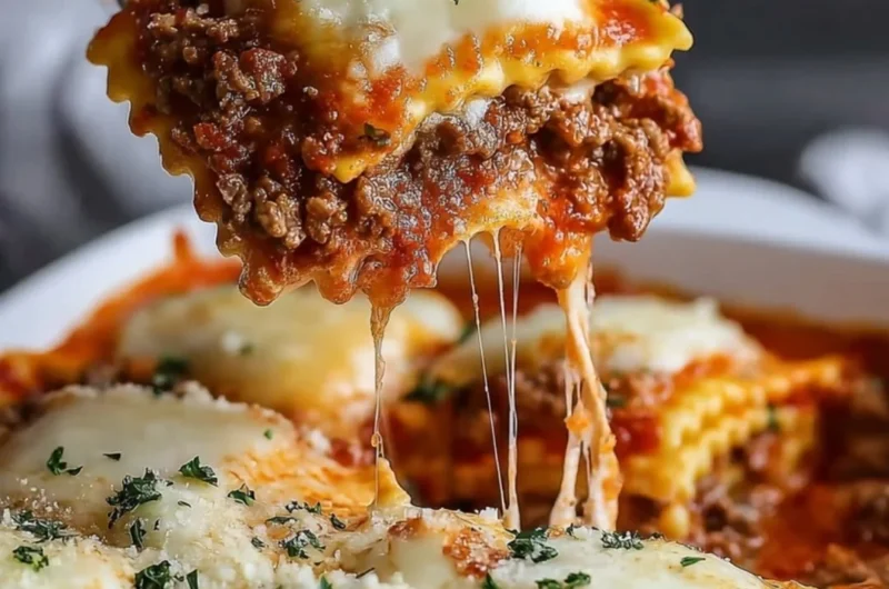 Delicious Million Dollar Ravioli Casserole topped with melted cheese and herbs