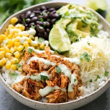 Delicious slow cooker chicken burrito bowl with fresh toppings and vibrant colors.
