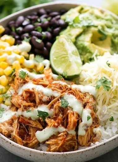 Delicious slow cooker chicken burrito bowl with fresh toppings and vibrant colors.