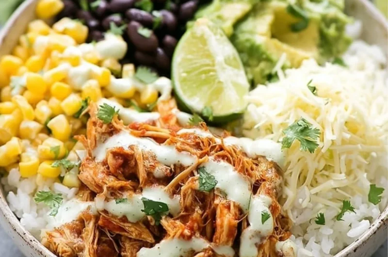 Delicious slow cooker chicken burrito bowl with fresh toppings and vibrant colors.