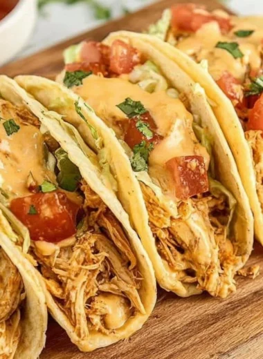 Delicious Slow Cooker Queso Chicken Tacos ready to serve.