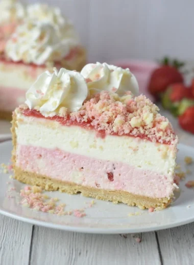Delicious Strawberry Crunch Cheesecake with a crunchy topping and strawberry layers.