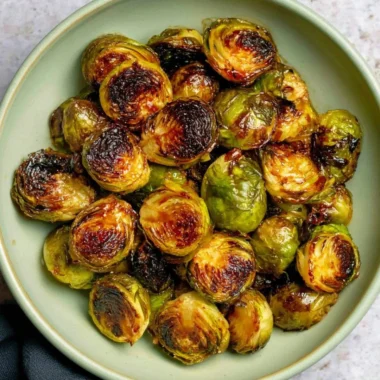 Oven roasted Maple Balsamic Brussels Sprouts with a drizzle of sauce
