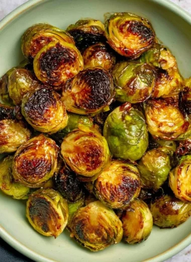 Oven roasted Maple Balsamic Brussels Sprouts with a drizzle of sauce