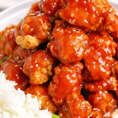 Delicious easy sesame chicken garnished with sesame seeds and green onions.