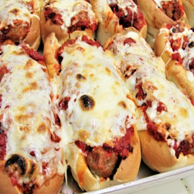 Oven baked meatball sandwiches with melted cheese and marinara sauce