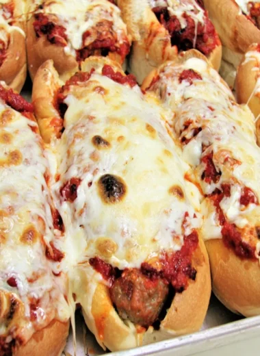 Oven baked meatball sandwiches with melted cheese and marinara sauce