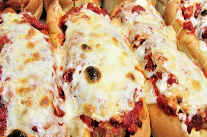 Oven baked meatball sandwiches with melted cheese and marinara sauce
