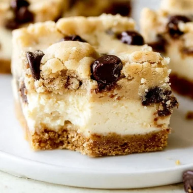 Decadent chocolate chip cheesecake bars with a rich crust and creamy filling
