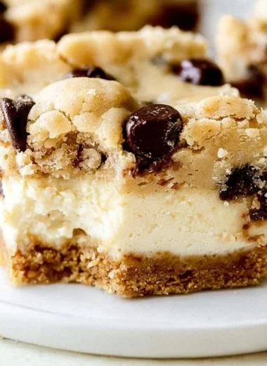 Decadent chocolate chip cheesecake bars with a rich crust and creamy filling